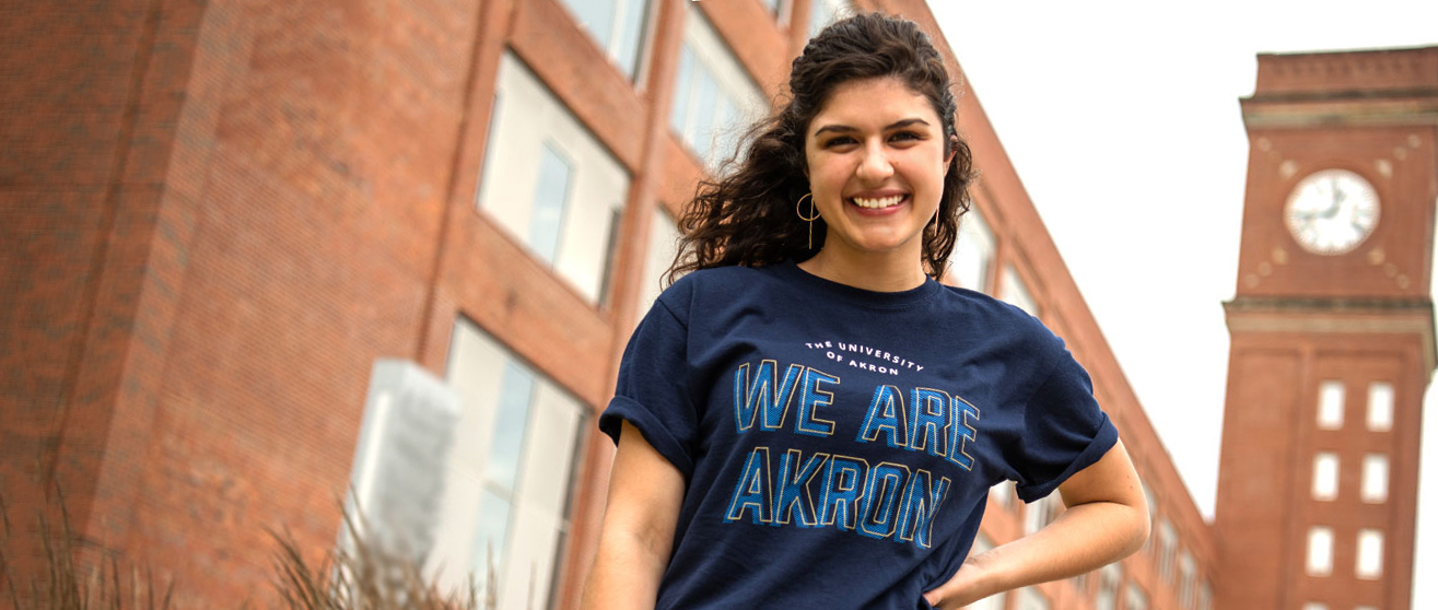 Student smiling on campus at the University of Akron