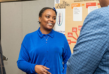 University of Akron student explains her analysis to a visitor during a presentation.