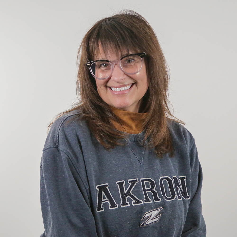 A student smiles at the camera wearing an akron sweatshirt