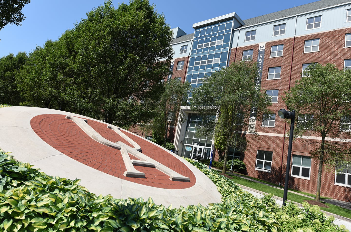 UA Logo with Williams Honor College in the Background