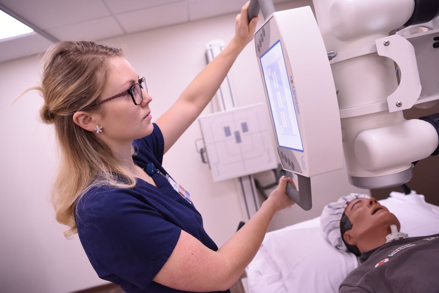 radiology student practicing on a dummy doll