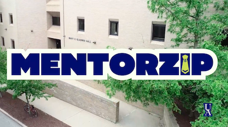 The word “MENTORZIP” in bold letters with a tie in place of the “I” is overlaid on a light brick building with trees and a bike along the sidewalk.