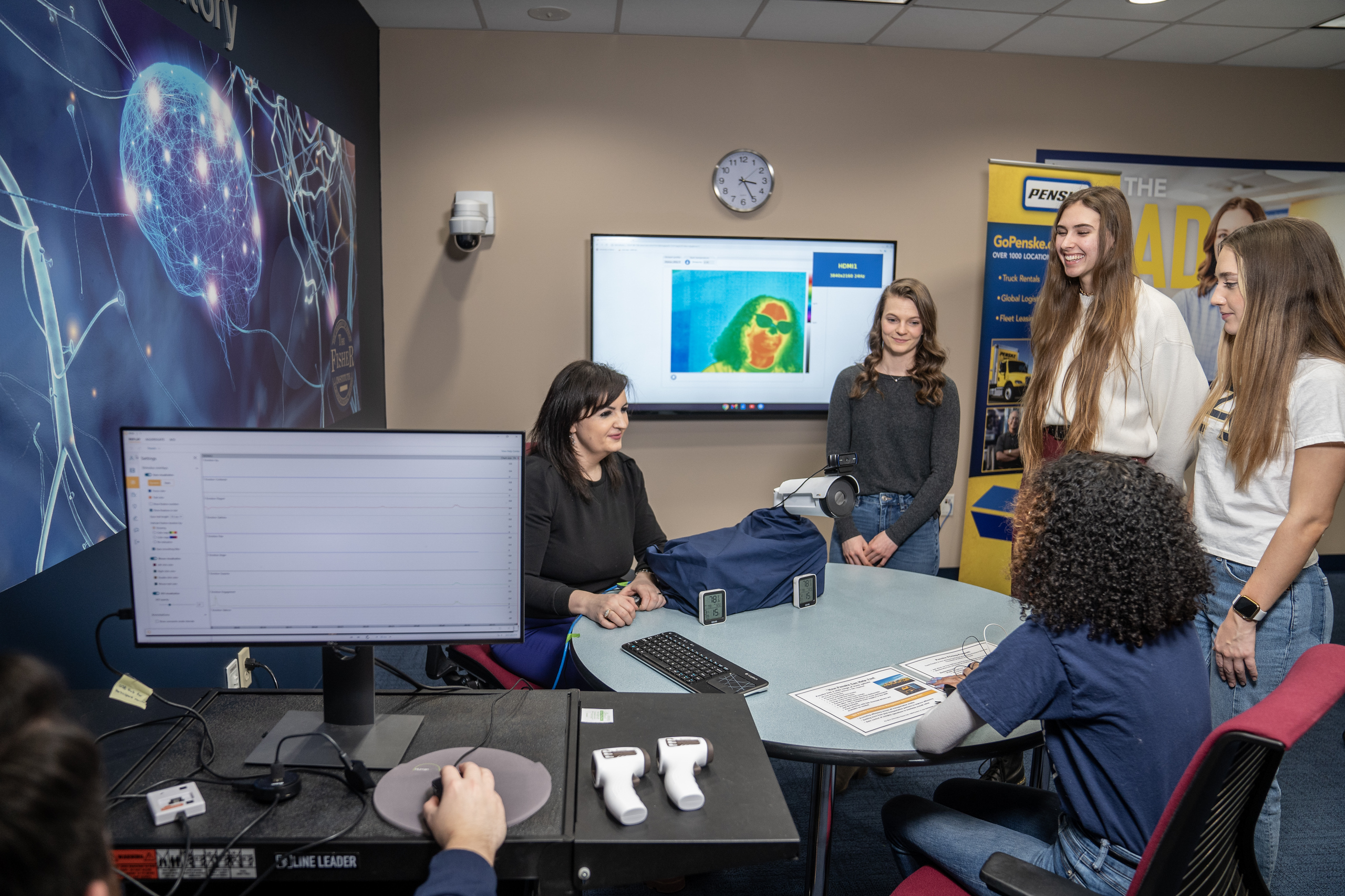 Students and professor working on hands on marketing lab