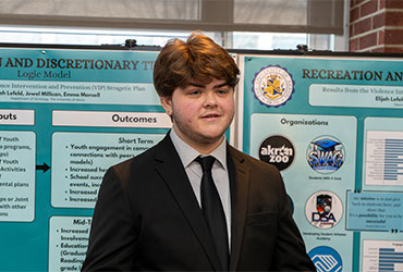 University of Akron student presents a project during a research poster session.