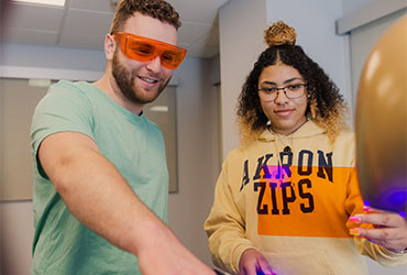 University of Akron students use infrared light and filters to examine evidence during a forensic science lab.