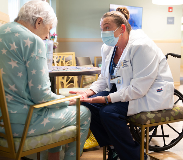 Graduate student working with an elderly patient