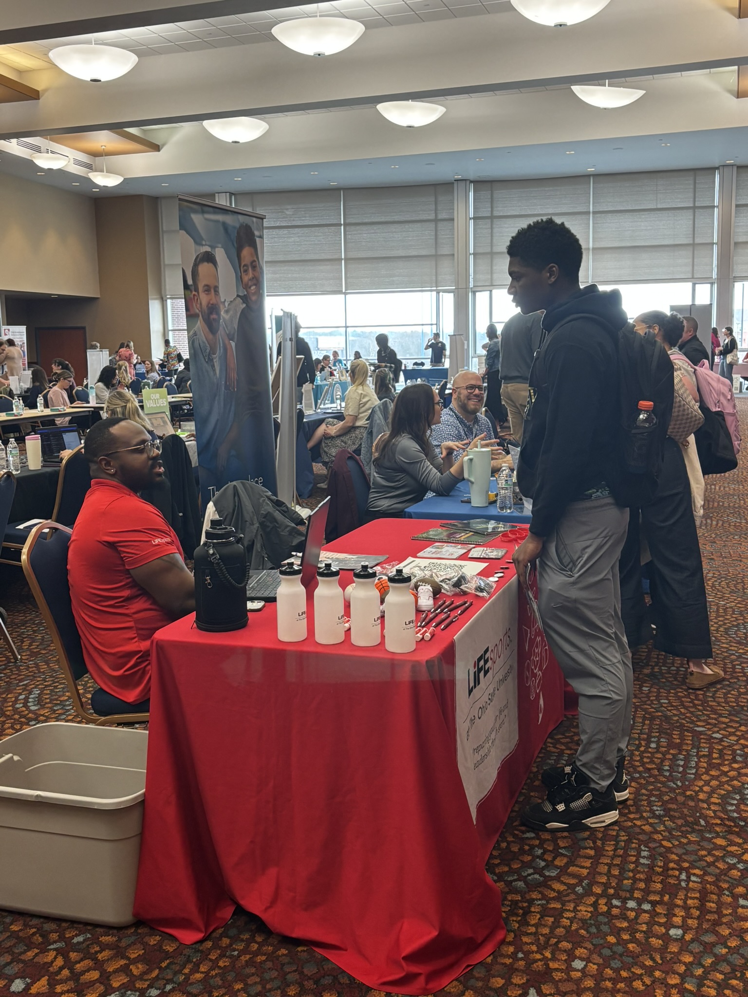 Image of student talking with an employer at career fair