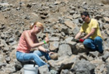 two students on a rocky hill