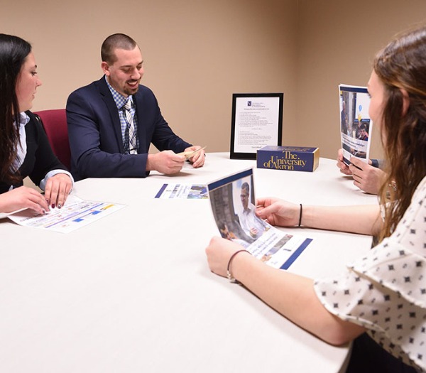 Students going over schedules in conference room