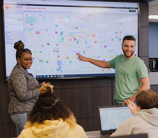University of Akron students present crime data on a digital map during a criminal justice classroom discussion.
