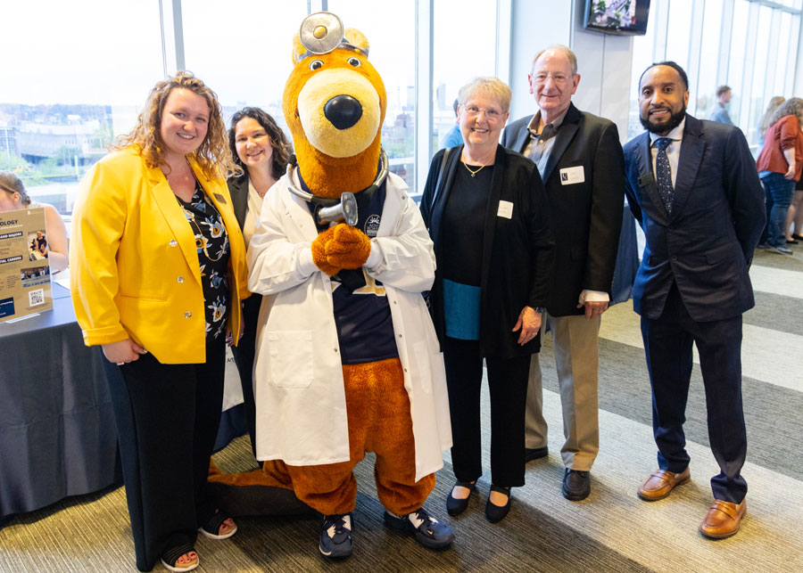 Five staff members, chairs and donors with Zippy