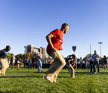 Students participating in a sack race