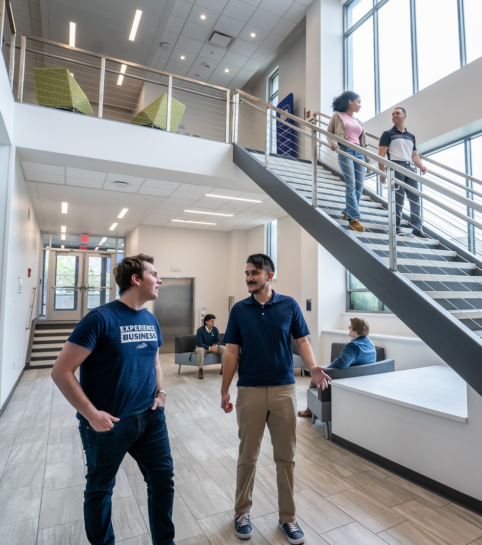 Students walking in the common areas of the College of Business
