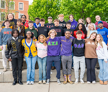 Fraternity and Sorority Life students outside wearing shirts with greek letters