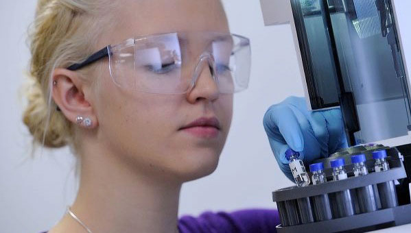 young caucasian woman with blonde hair in a pony tail wearing safety goggles