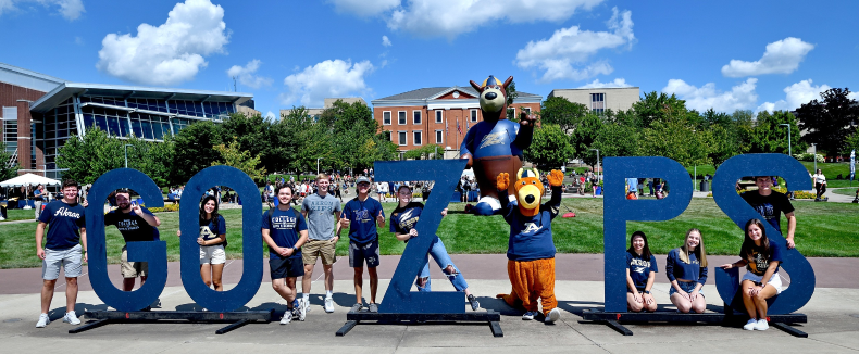 University of Akron students outdoors posing with Zippy