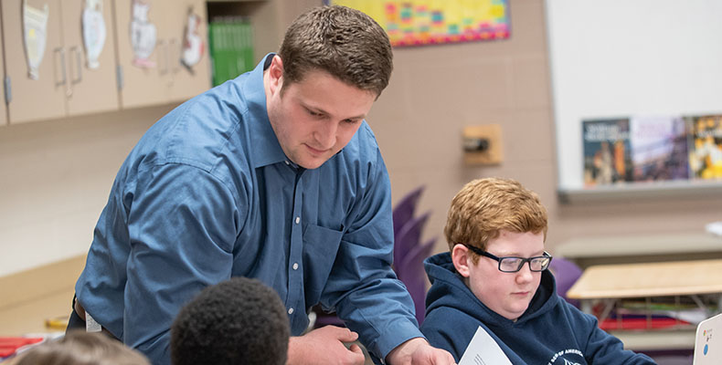 young man teaching in classroom