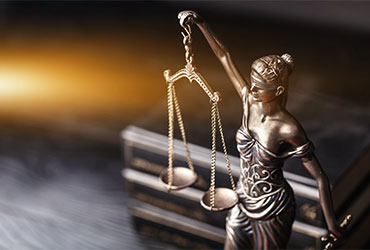Statue of Lady Justice holding balanced scales, symbolizing law, justice and the criminal justice profession.