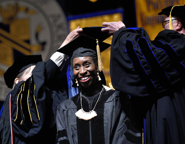 Smiling UA graduate student at commencement