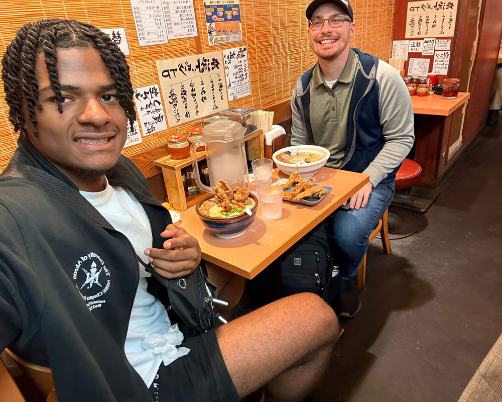 Winsten Lomax and Jason Mack eating a meal.