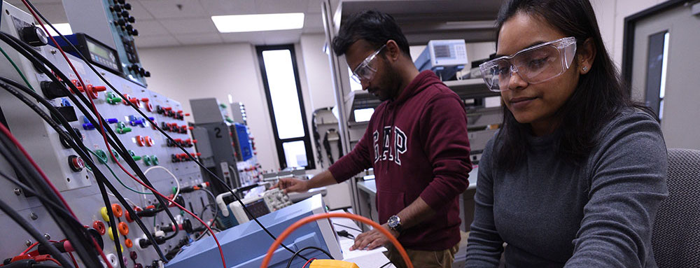 International students working in engineering classroom